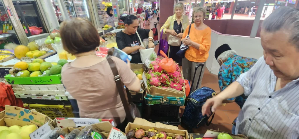 Shoppers at a fruit stall inside Tekka Centre in Singapore during the daily market bustle