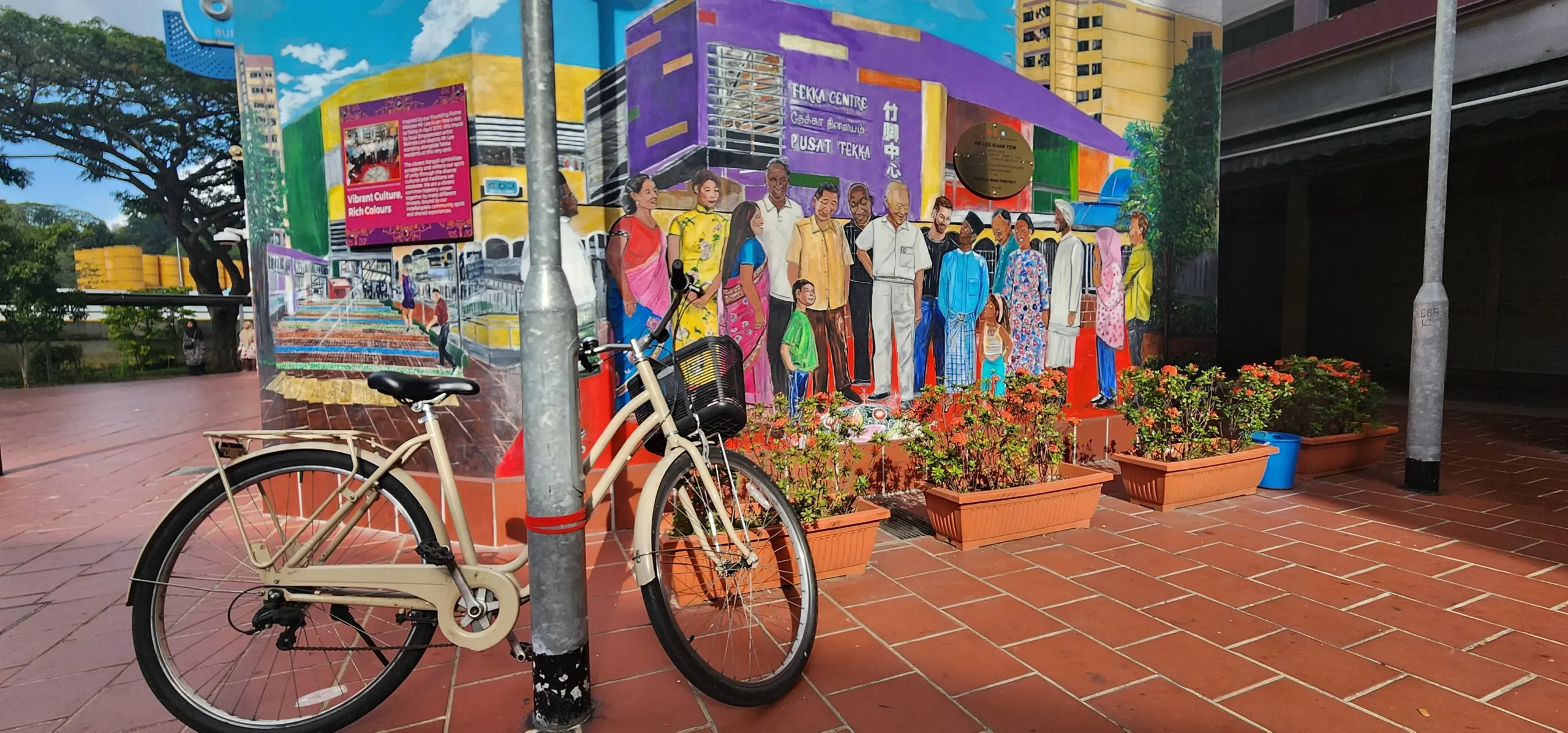 Bicycle parked in front of the Tekka Centre mural in Singapore reflecting vibrant culture and community