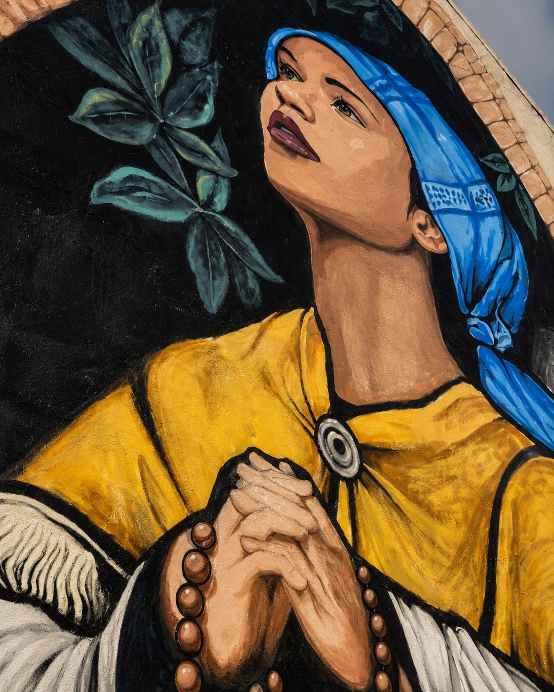 Reflective mural of a prayerful figure, symbolising hope, dignity, faith and quiet strength during difficult seasons of life.