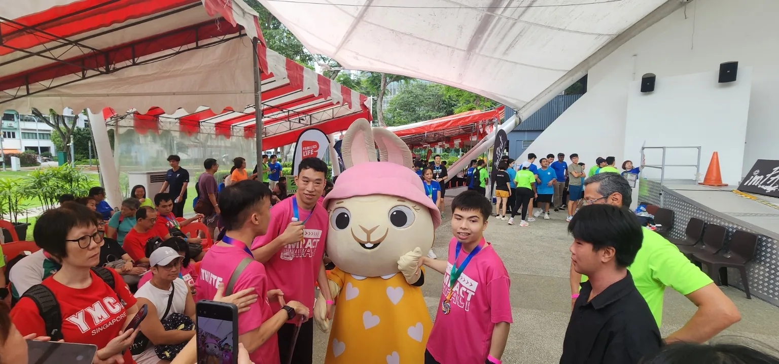 Family friendly community moment at Beyond Limits 2026 with participants and mascot