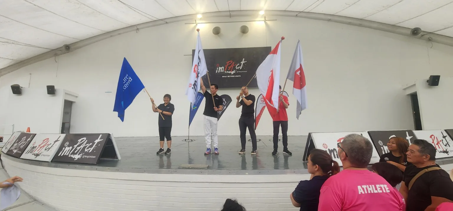Community closing moment at Beyond Limits 2026 with flags on stage in Singapore