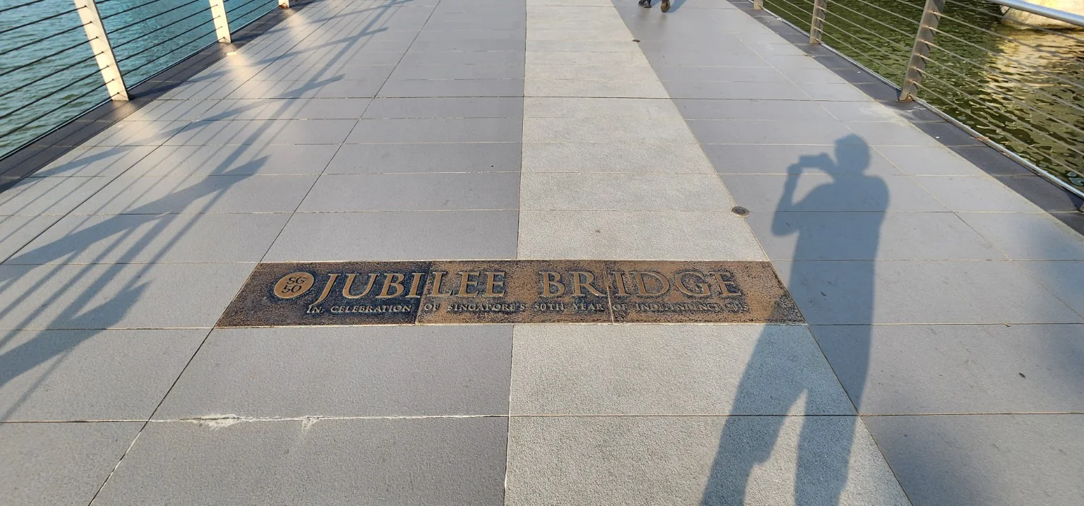 Jubilee Bridge marker and the photographer's morning shadow