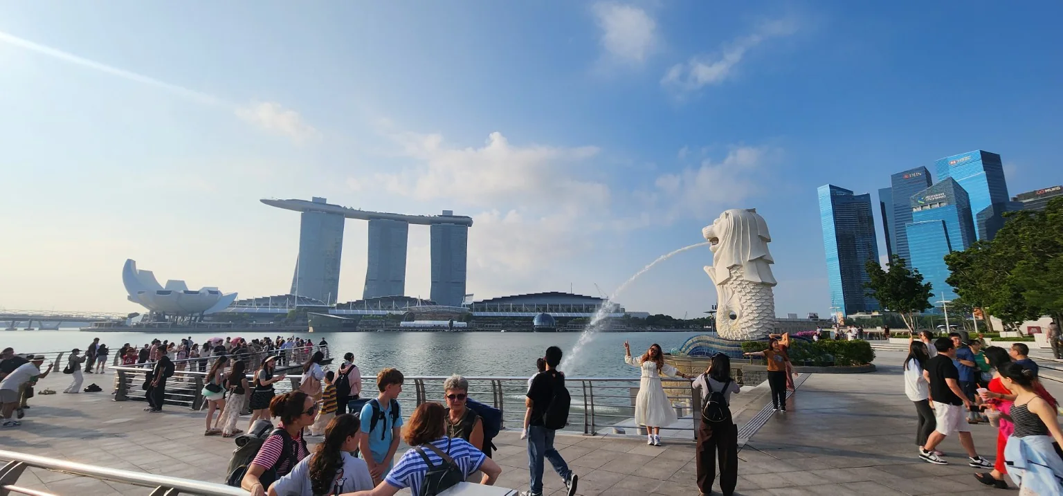 Merlion Park with Marina Bay Sands and visitors around the waterfront