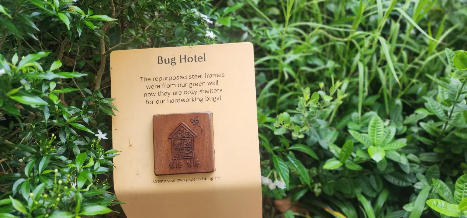 Bug Hotel marker explaining how former green-wall steel frames were repurposed as insect shelters