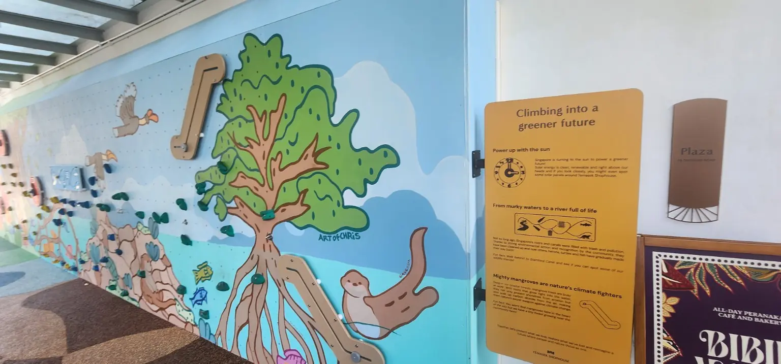 Interactive climbing wall introducing solar power, river life and mangroves at Temasek Shophouse