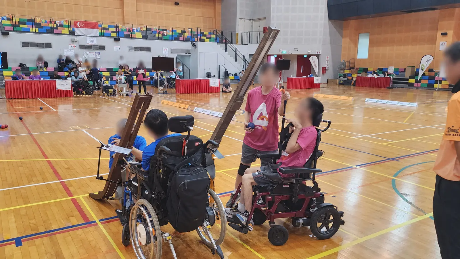 Boccia athlete working with a ramp operator during competition at Pesta Sukan in Singapore
