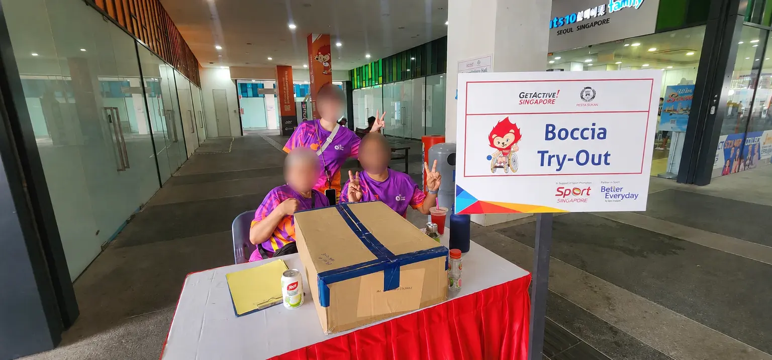 Friends of SDSC volunteers welcoming visitors at a boccia try-out desk